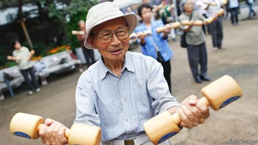 Japanese man holding hand weights